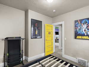 Unfurnished bedroom with a textured ceiling and baseboards