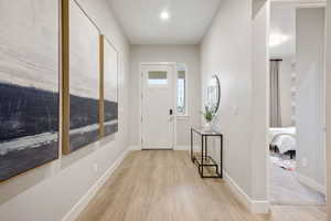 Entryway featuring light wood-type flooring and baseboards