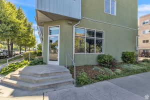 View of exterior entry featuring stucco siding