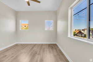 Unfurnished room with light wood-type flooring and a ceiling fan