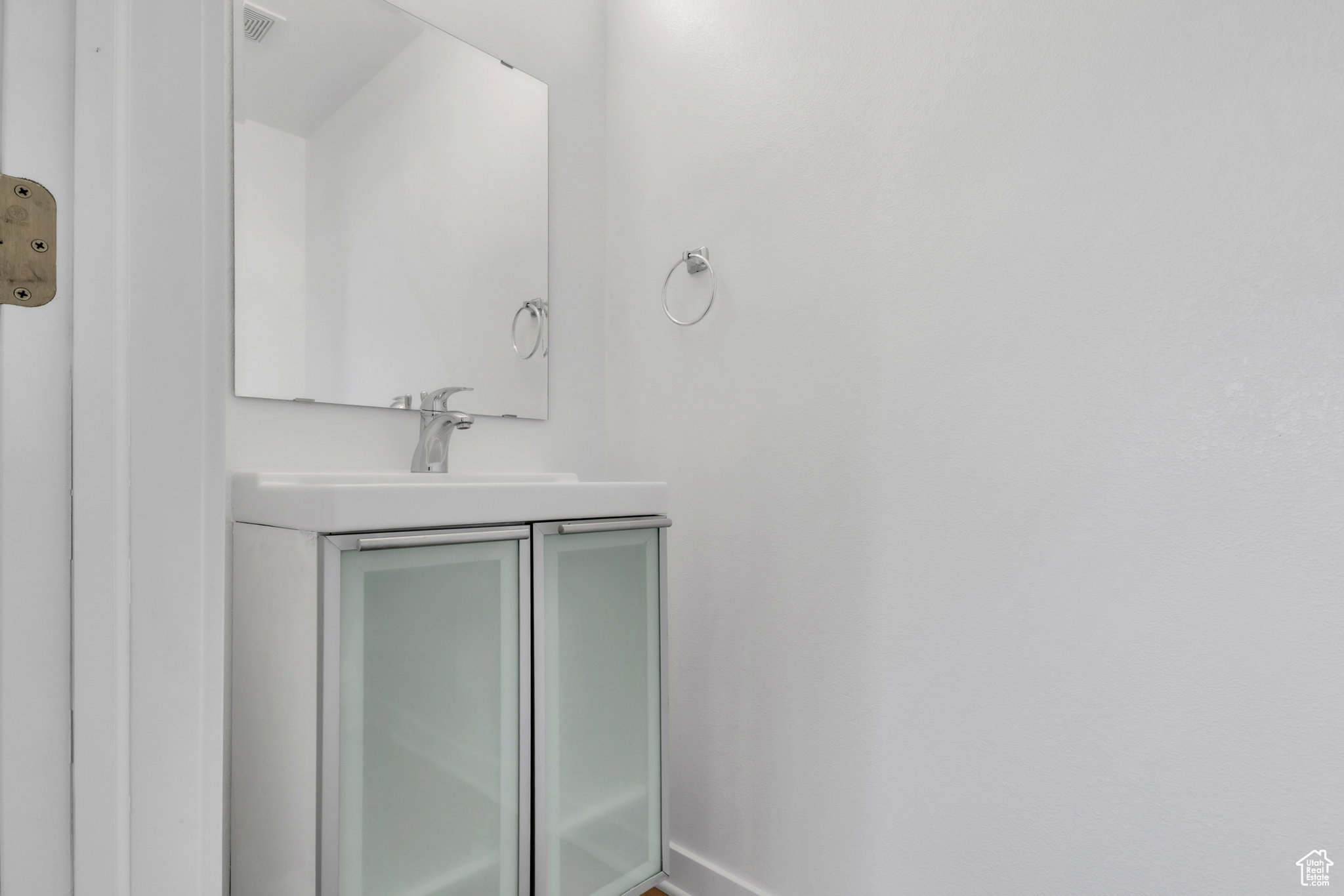 Bathroom with vanity and baseboards