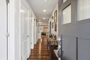 Corridor with recessed lighting and dark wood finished floors
