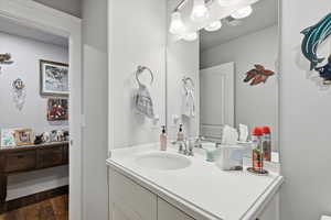 Bathroom featuring vanity and dark wood finished floors