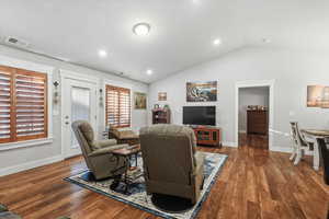 Living area featuring vaulted ceiling, wood finished floors, and recessed lighting