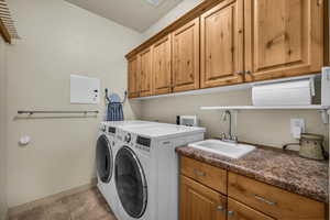 Laundry area featuring cabinet space and washing machine and dryer