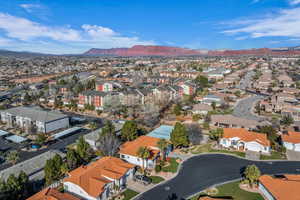 Aerial perspective of suburban area featuring a mountainous background
