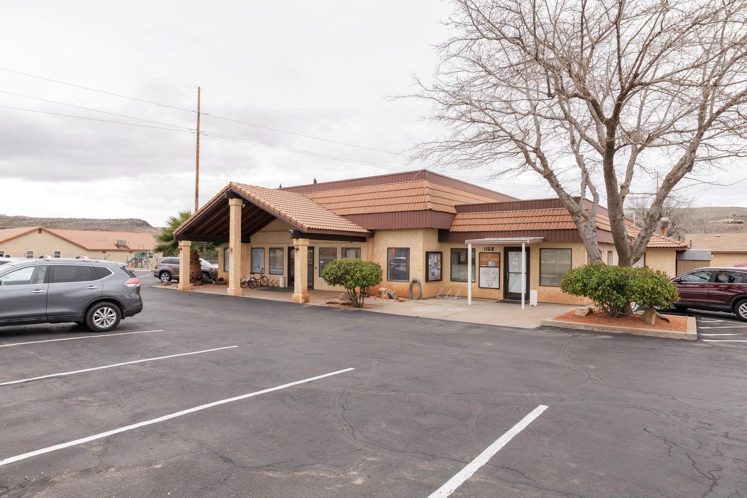 View of building exterior with uncovered parking