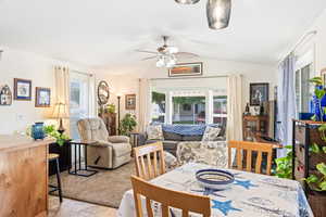 Dining room featuring lofted ceiling and ceiling fan