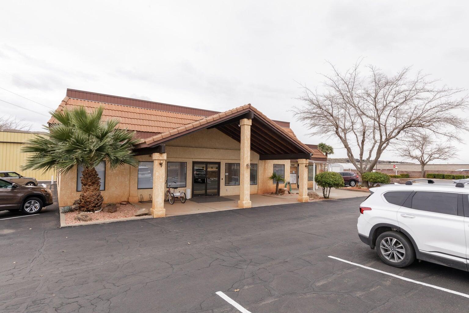 View of property with uncovered parking