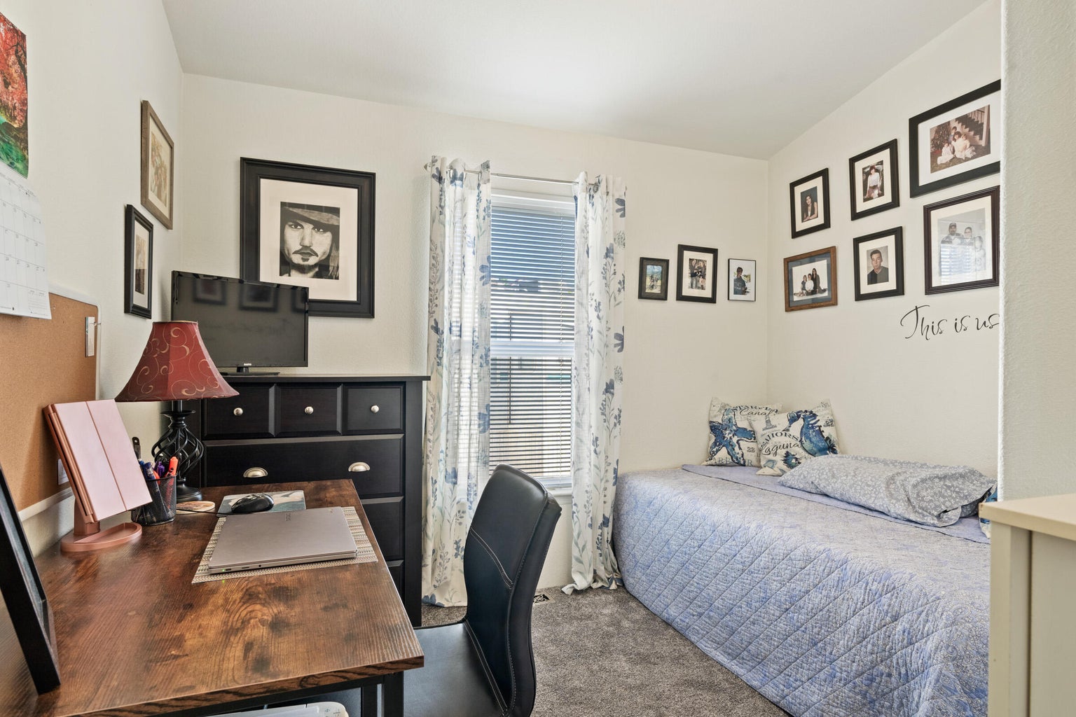Carpeted bedroom with an office area