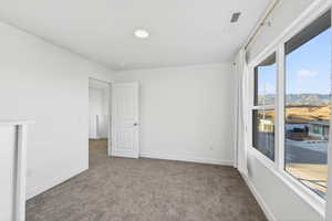 Empty room with carpet floors and a mountain view