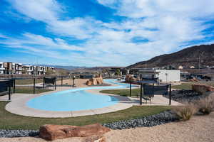 View of swimming pool with a patio, a pool, a mountain view, and a lawn