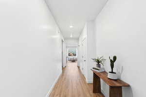 Hall featuring light wood-style floors and recessed lighting