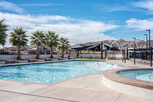 Community pool with a patio, a community hot tub, and a mountain view