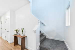Stairs featuring baseboards and wood finished floors