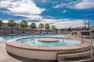 Community pool featuring a patio area and a hot tub