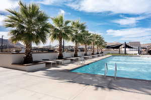 Community pool featuring a mountain view and a patio