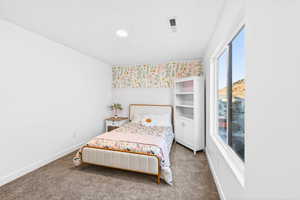 Carpeted bedroom with baseboards