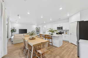 Dining space featuring light wood-style flooring and recessed lighting