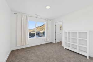 Unfurnished bedroom with carpet and baseboards