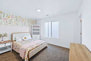 Bedroom with baseboards and dark carpet