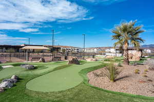 View of property's community featuring a putting green and a residential view