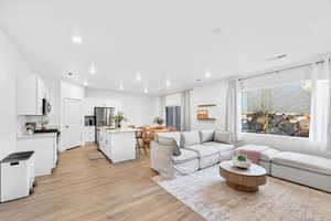 Living room featuring light wood-style floors and recessed lighting