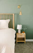 Carpeted bedroom featuring baseboards