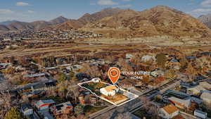 Aerial view of residential area featuring a mountain backdrop