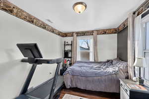 Bedroom with dark wood finished floors