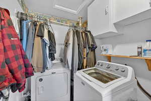 Laundry room with attic access and washer and clothes dryer