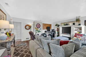Living room with dark wood-type flooring