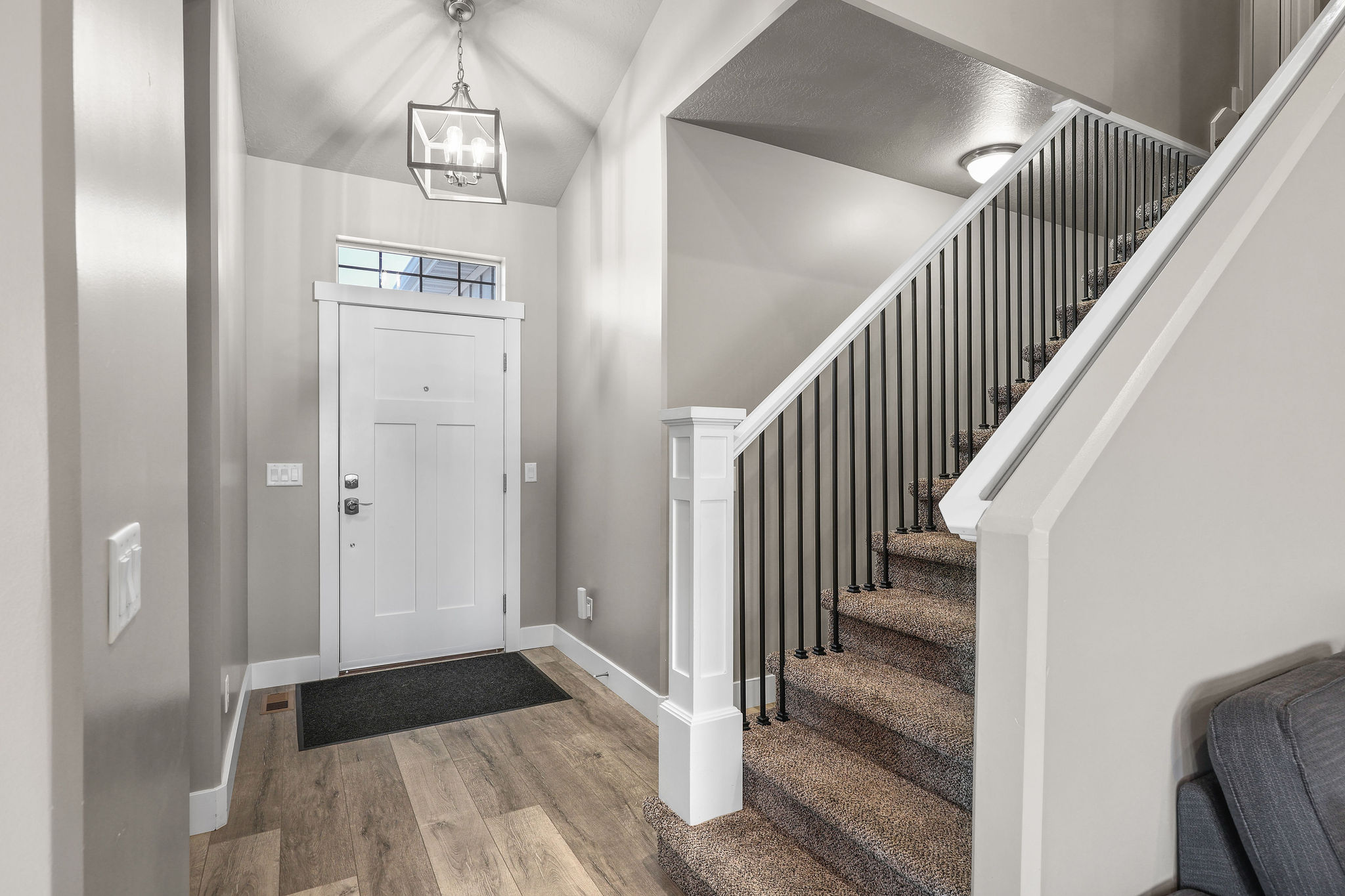 Foyer entrance featuring wood finished floors, stairs, and a chandelier