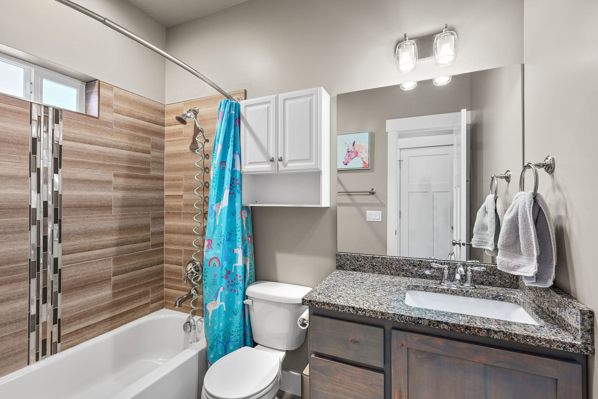 Bathroom featuring shower / tub combo with curtain and vanity