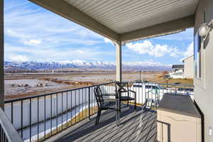 Balcony featuring a sunroom and a mountain view