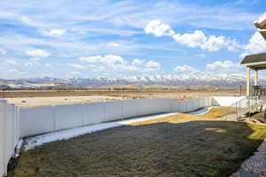 Fenced backyard with a mountain view, a patio area, and stairway