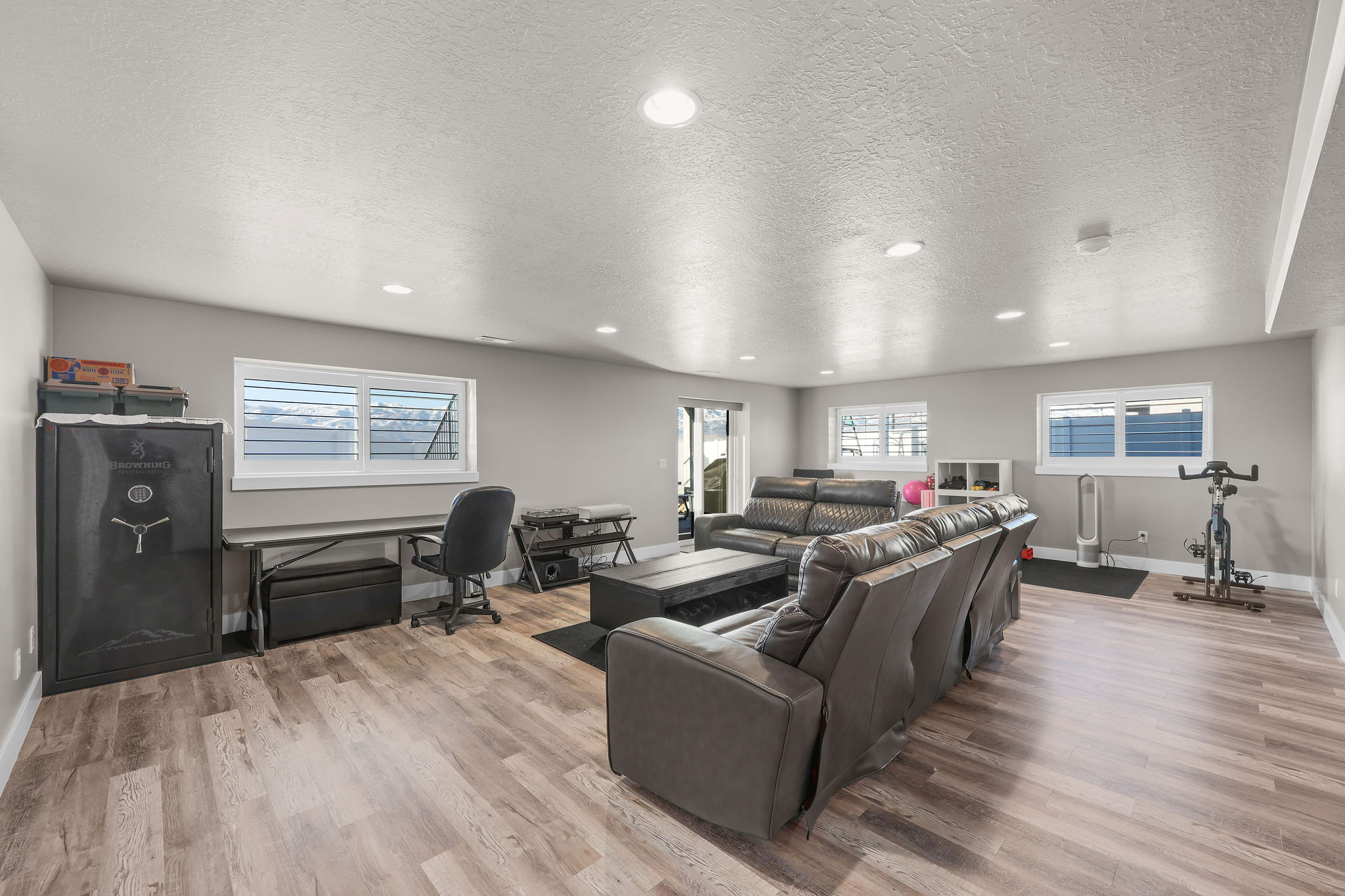 Living room featuring a desk, recessed lighting, a textured ceiling, and light wood-style floors