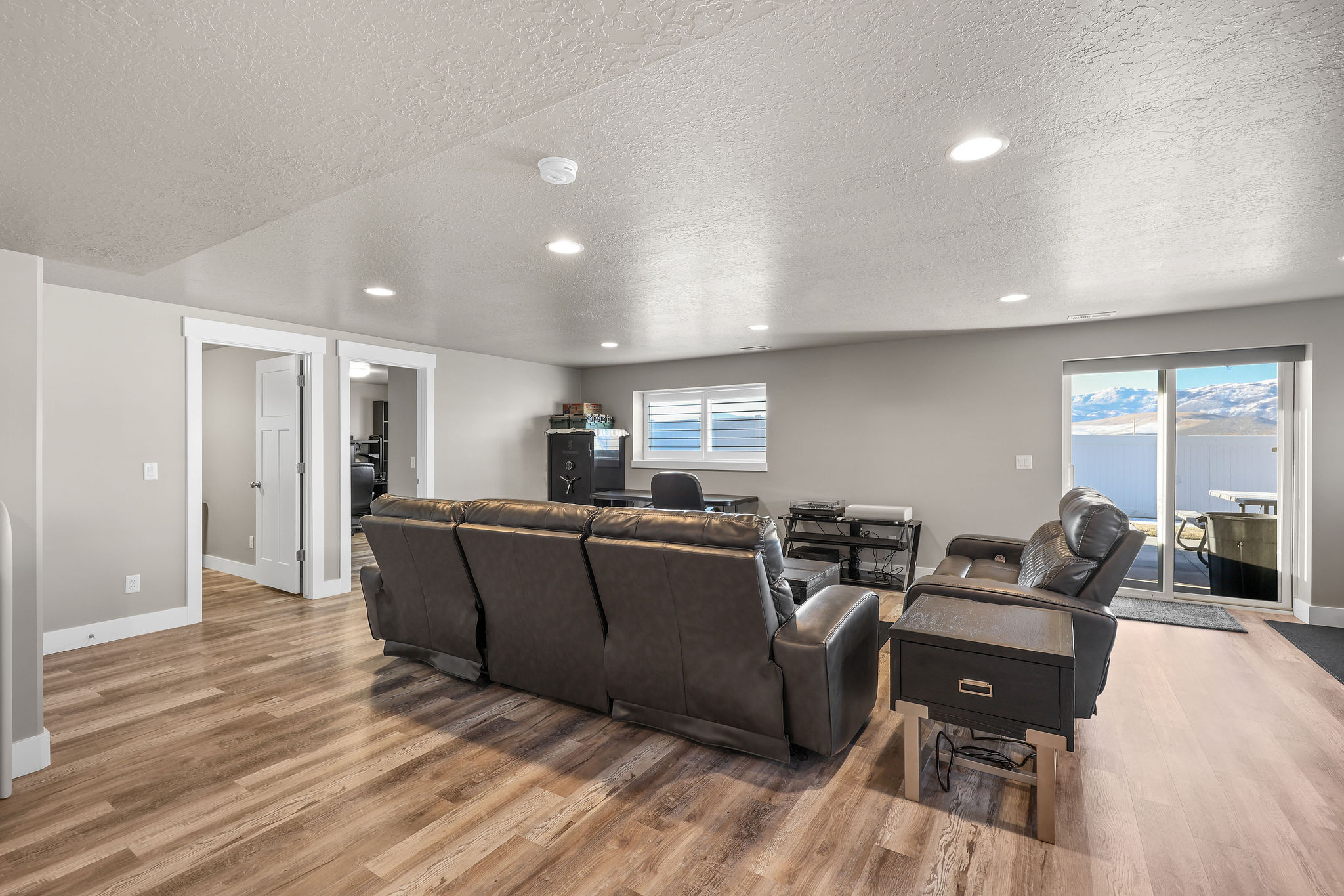 Living room featuring recessed lighting, a textured ceiling, and light wood-type flooring