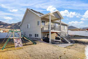 Back of house featuring a patio area, a fenced backyard, stairs, and a playground