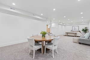 Dining area featuring recessed lighting and light carpet