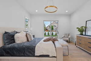 Bedroom with wood finished floors, recessed lighting, and access to outside