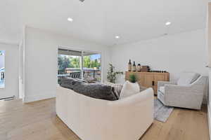 Living room featuring light wood-style floors and recessed lighting