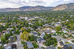 Aerial view of property's location featuring a mountainous background and nearby suburban area