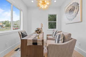 Dining room featuring recessed lighting, a chandelier, healthy amount of natural light, a mountain view, and light wood finished floors