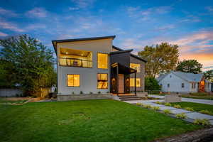 View of front facade featuring a balcony and stucco siding