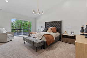 Bedroom with carpet floors, access to exterior, a chandelier, and high vaulted ceiling