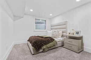 Bedroom featuring light carpet and recessed lighting