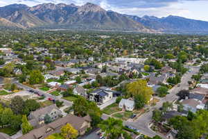 Aerial view of property's location featuring a mountainous background and nearby suburban area