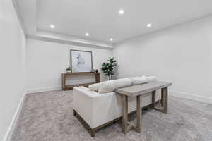 Living room with light carpet and recessed lighting