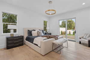 Bedroom with access to exterior and light wood-style floors